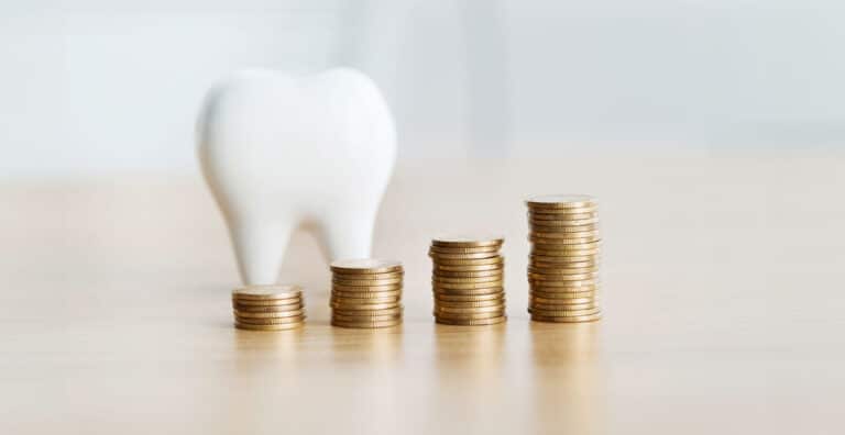 Penger og tann som illustrerer hvem som betaler for tannlegetimen